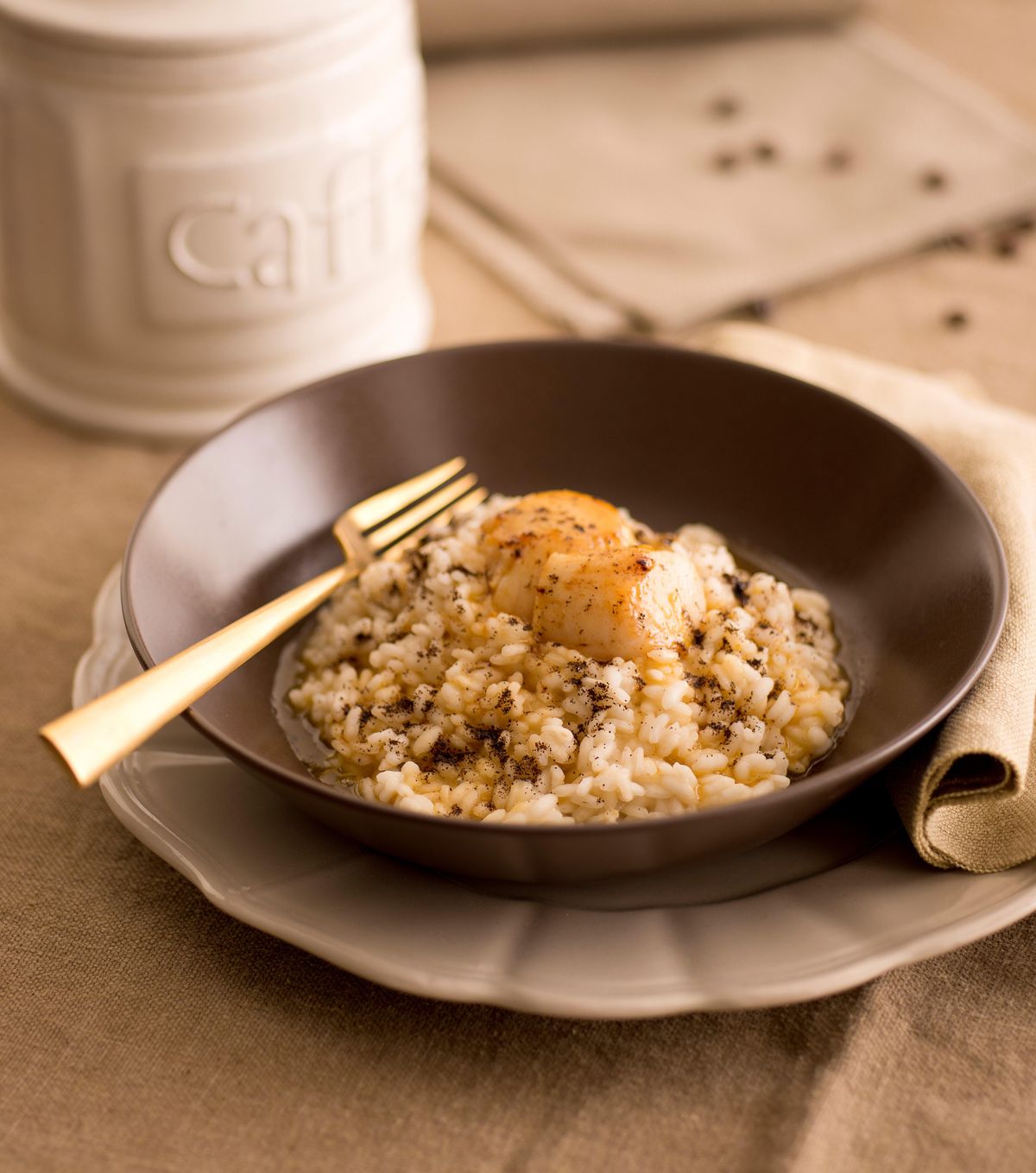 Coffee risotto with lemon zest and scallops