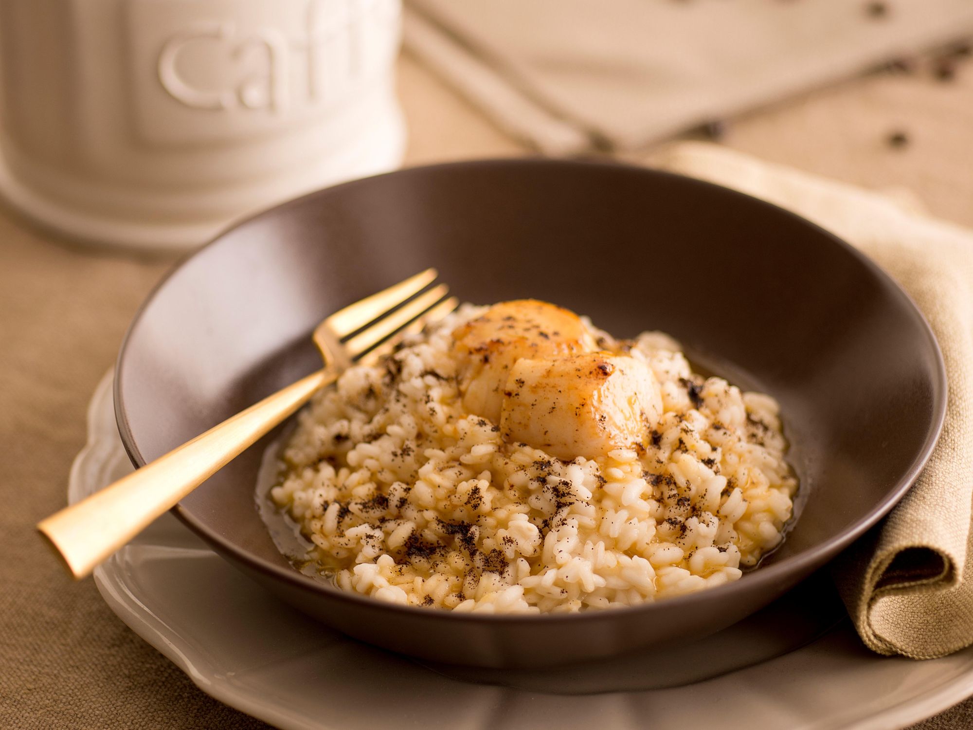 Coffee risotto with lemon zest and scallops