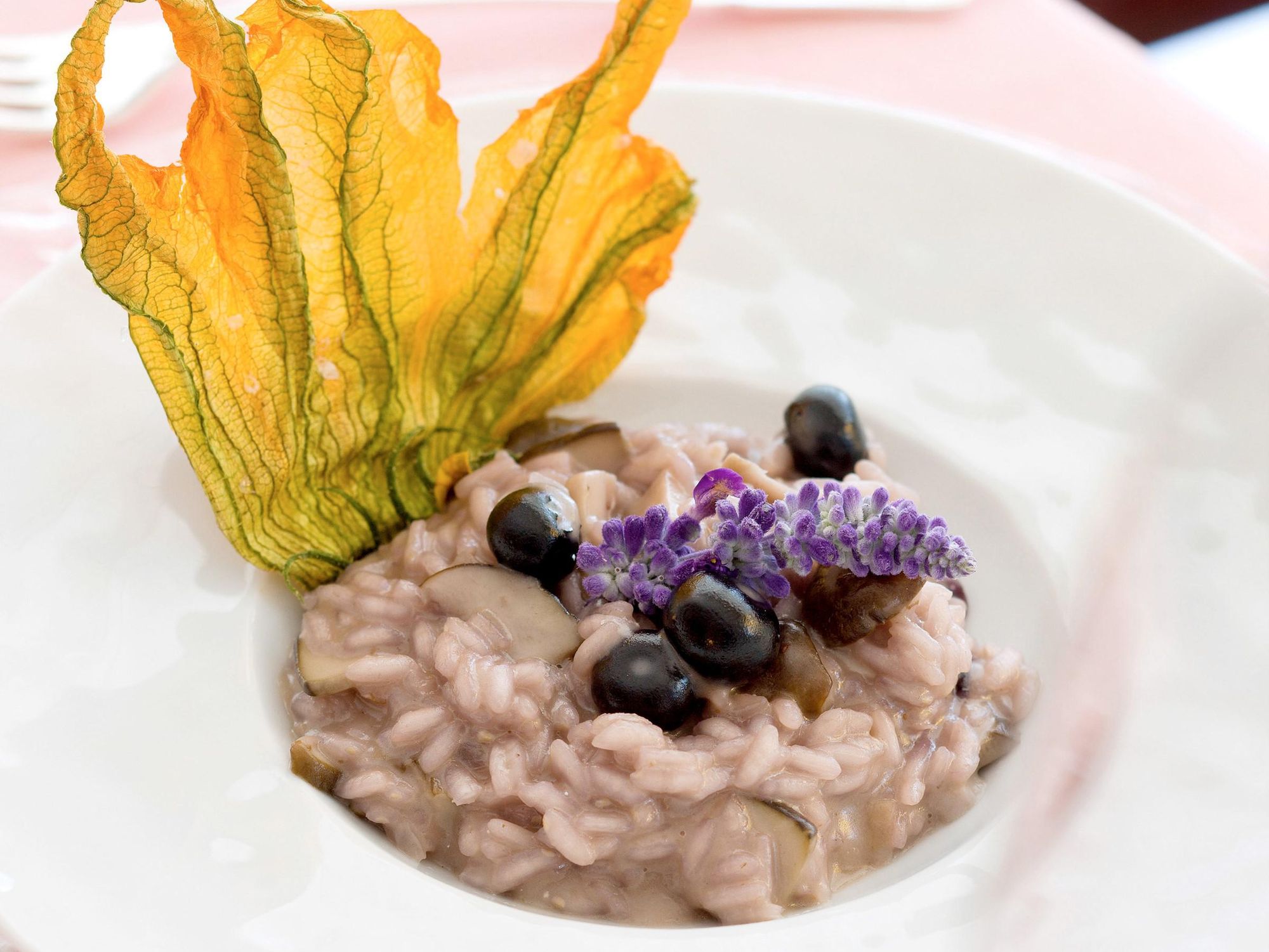 Penny buns and blueberries rice with zucchini blossoms