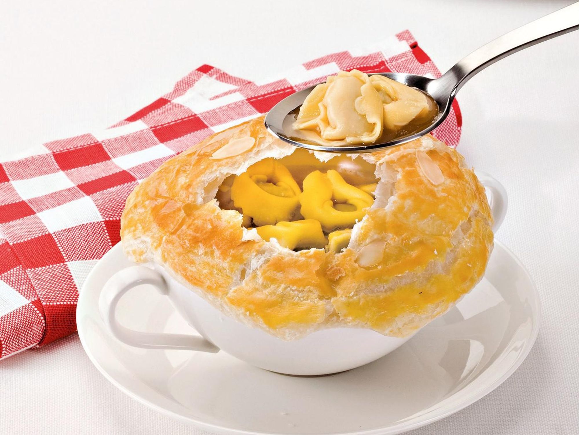 Tortellini in broth with puff pastry crust